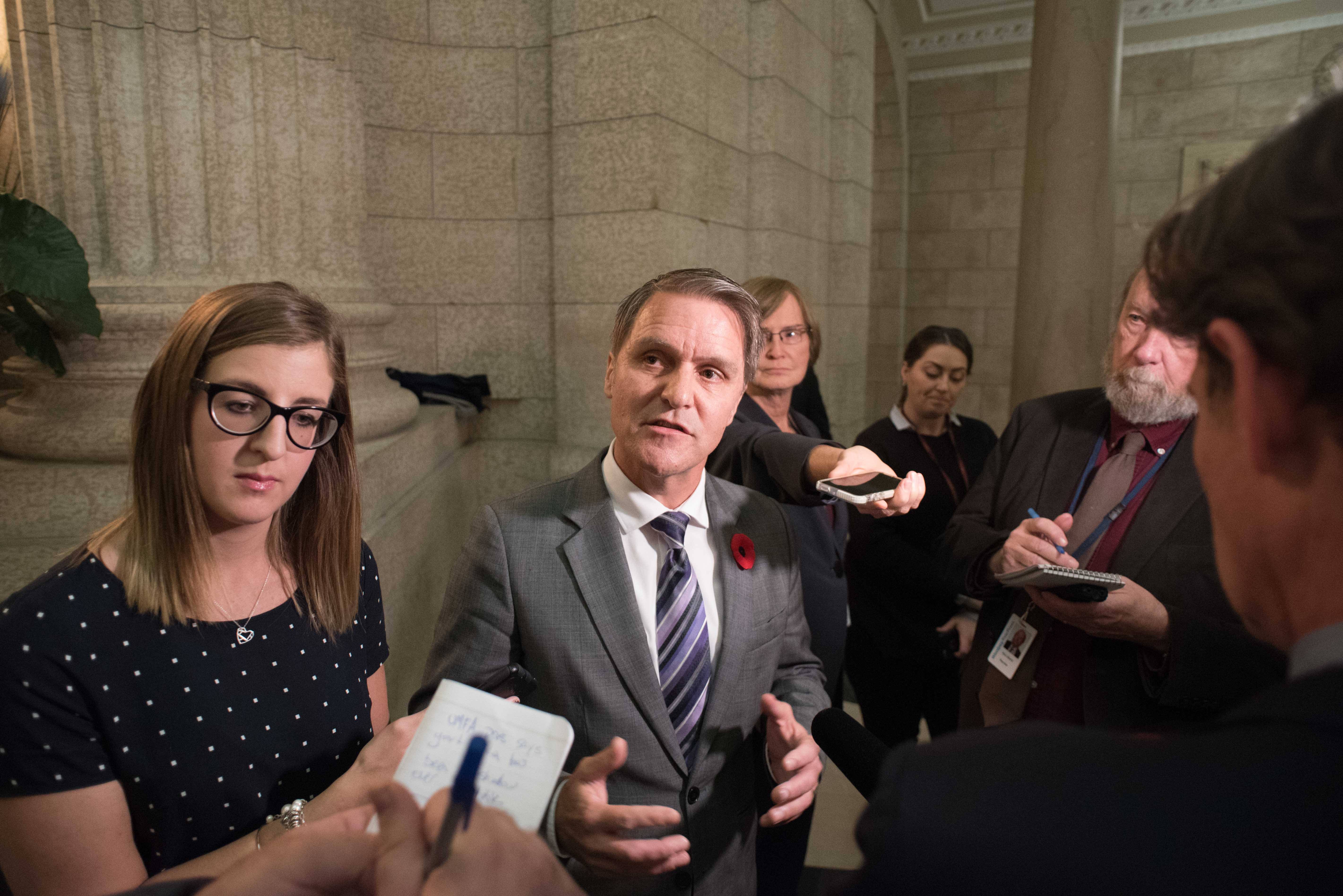 Minister of Finance, Cameron Friesen in press scrum, gives a statement to the Manitoban. Photo by Miguel Yetman