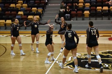 The Bison women's volleyball team celebrate after winning a point against the UBC Okanagan Heat on Feb. 17 at the Investors Group Athletic Centre in Winnipeg.